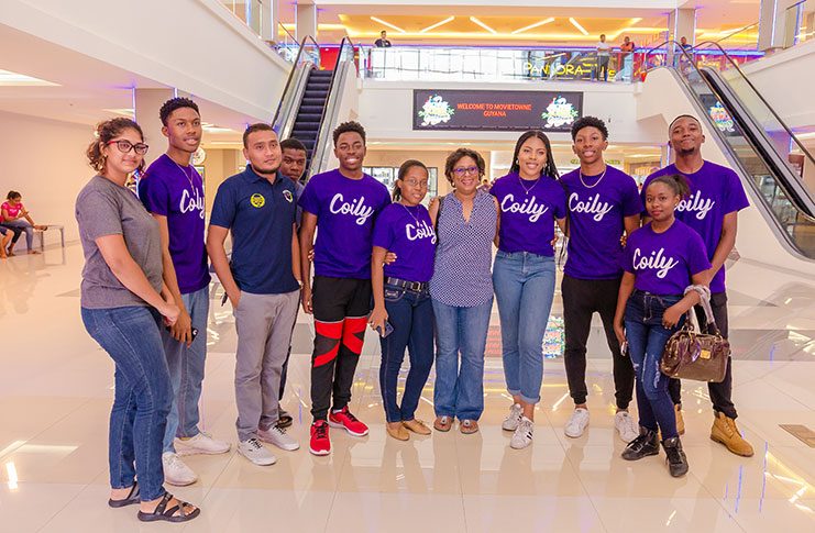 Public Telecommunications Minister, Cathy Hughes shares a photo with ‘Coily’ team members, including its Primary Developer, Asha Christian, fourth right (Delano Williams photo)