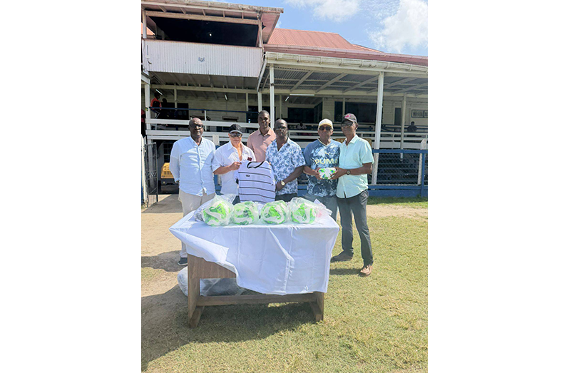 GPF Sports Development Officer, Colin Boyce, receives part of the gear from an executive of Pele Alumni Corporation