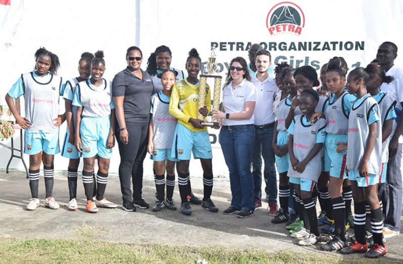 Girls’ Champion Charlestown collect their trophy from ExxonMobil’s Deebra Moe