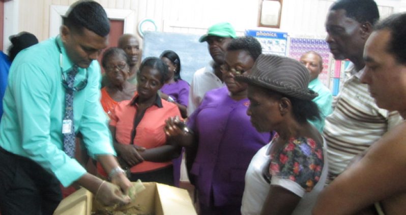 Solid Management Director Walter Narine (extreme left) briefing residents on composting practices and other waste management methods