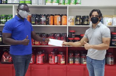 President of the GBBFF Keavon Bess (left) collects sponsorship cheque from proprietor of Fitness Express, Jamie McDonald.  The presentation was made last week.