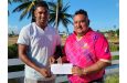 Vice-President of the Essequibo Cricket Board Norwayne Fredricks (left), collects the financial contribution from Chief Executive Officer of FL Sport, John Ramsingh