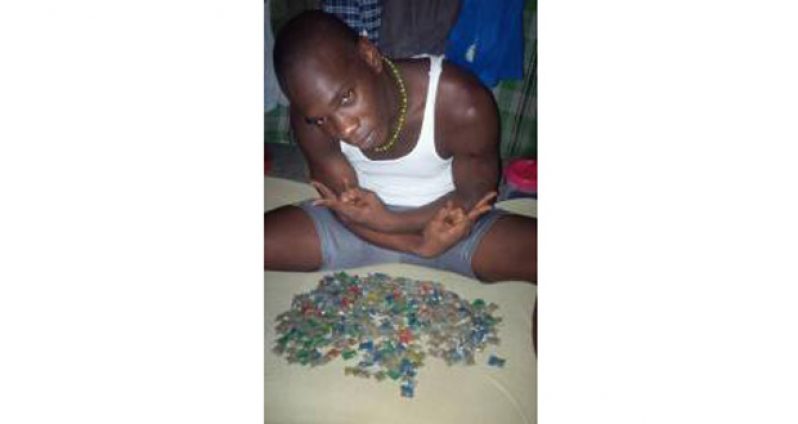 Collis Collison poses with several bags of marijuana while in the Georgetown Prison