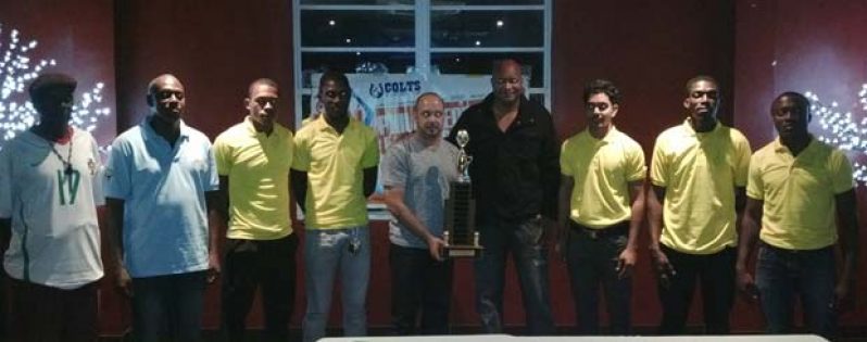 GABA President Michael Singh and GABF President Nigel Hinds, poses with the Philip George Memorial basketball trophy at yesterday’s launching, with other players and officials.