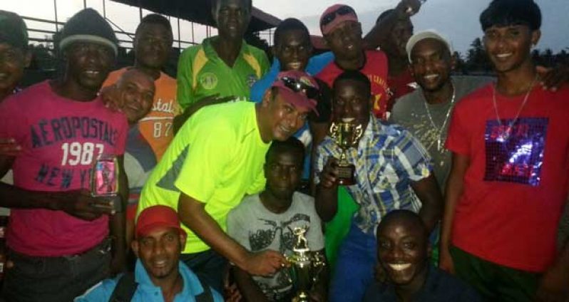 The champions Combined XI with manager Anil Persaud (in light green), display broad smiles after being crowned champions of the Quest International/Arrival Day T20 tournament last Monday.