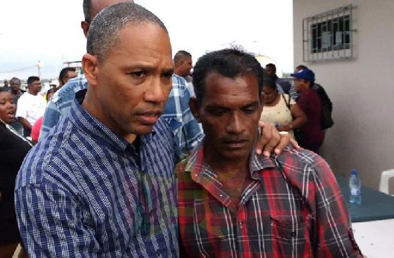 uriname’s Minister of Justice and Police, Mr Stuart Getrouw comforting one of the Guyanese fishermen at Saturday’s meeting (Photo by René Gompers courtesy of Starnieuws)