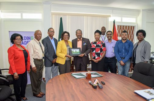 Computer UG’s Vice Chancellor (VC), Professor Ivelaw Griffith receives one of the 20 laptops from Minister of Public telecommunications Cathy Hughes in the presence of staffers of UG and the Ministry. The laptops were donated by the Ministry of Public Telecommunications for lecturers at UG