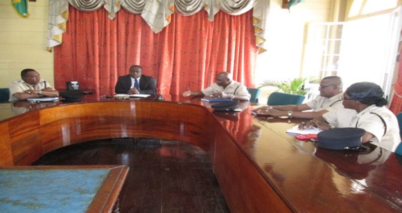 Town Clerk Royston King (centre) with law-enforcement officers at the partnership meeting