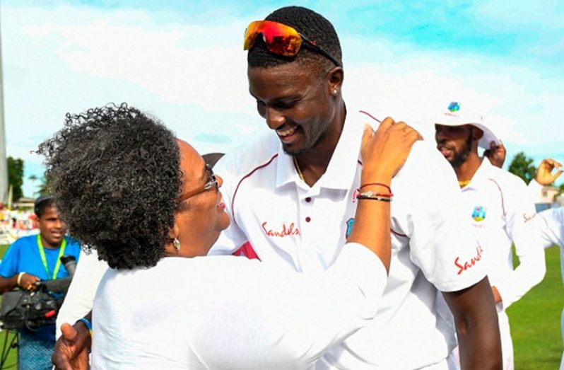 Mia Mottley Prime Minister of Barbados congratulate Jason Holder (R) of West Indies for winning on day 4 of the 1st Test between West Indies and England at Kensington Oval, Bridgetown, Barbados, on January 26, 2019. (Photo by Randy Brooks / AFP) (Photo credit should read RANDY BROOKS/AFP/Getty Images)
