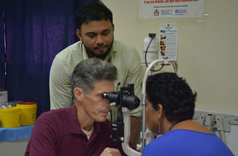 U.S Corneal Transplant Specialist, Dr. Joseph Pasternak and Head of the GPHC Ophthalmologist Department, Dr. Shailendra Sugrim, screening one of the patients prior to the surgery. (Photo by Richard Mohase)