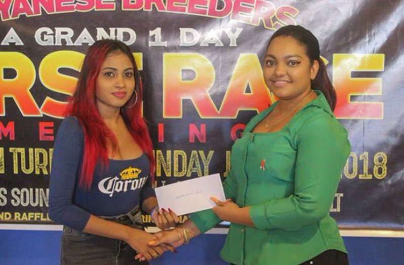 A representative of Corona Beer (left) presents the company’s sponsorship.