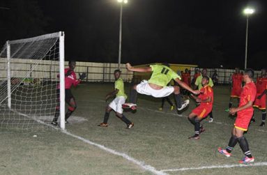 Ron Wilson (#11) of Cougars is airborne as he aims to head home this corner kick against Soesdyke but the ball is saved by goalkeeper Javier Greene (left).