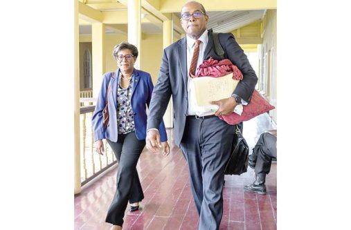 Attorney Nigel Hughes alongside his wife, Catherine at the High Court in Georgetown