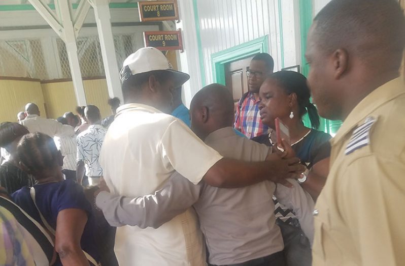 Relatives of the accused crowding the corridor of the High Court, hugging the accused after they were freed