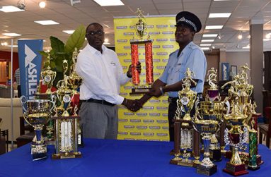 COURTS Finance Director Neil Boucher (left) hands over one of the trophies to Assistant Coordinator of the Police Championships, Lyndon Wilson.