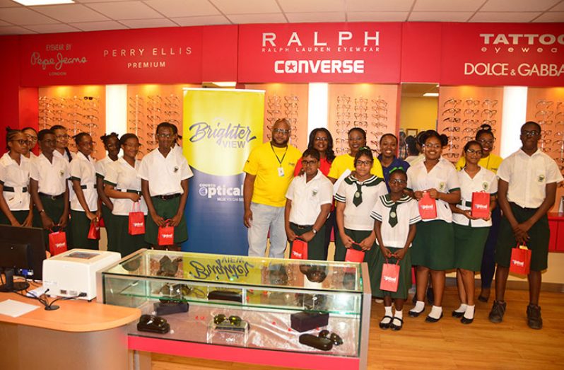 Officials of Courts sharing a moment with the students who received glasses (Adrian Narine photo)