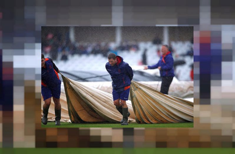 Ground staff put covers on the pitch as rain delays play. (Action Images via Reuters/Andrew Boyers/File photo)