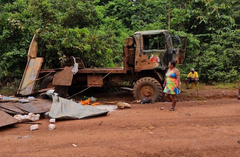 Residents of the area looked at the truck in the aftermath of the fatal accident on the 26 Miles Public Road, Port Kaituma