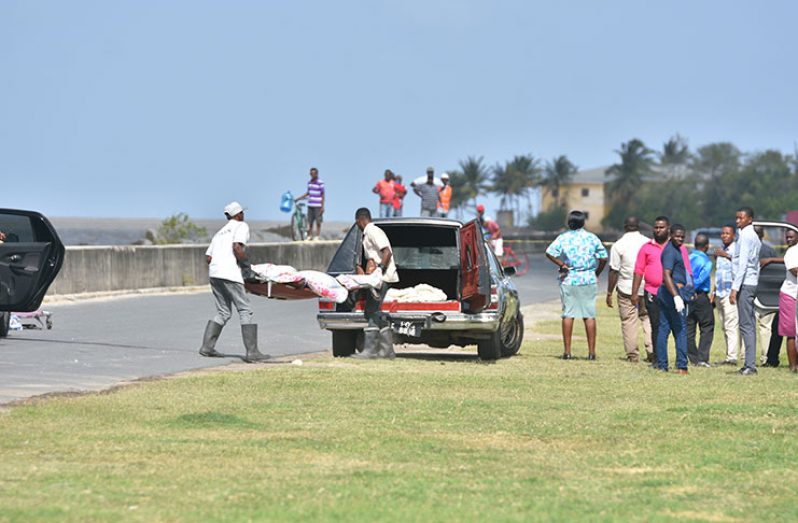 The remains of the suspected bandits being removed from the scene (Samuel Maughn photo)