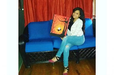 Cristal Simmons showcasing one of her art pieces