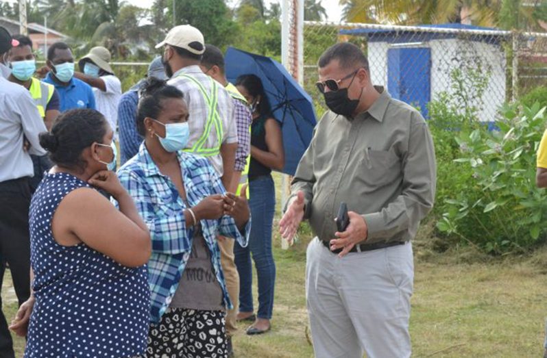 Minister of Housing and Water, Collin Croal engaging residents
