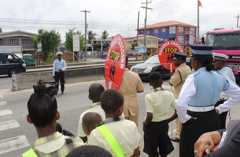 Police officers and teachers, along with the students being trained to recognise traffic safety, as well as how to properly use the pedestrian crossing to assist in keeping their peers safe on their journey to and from school