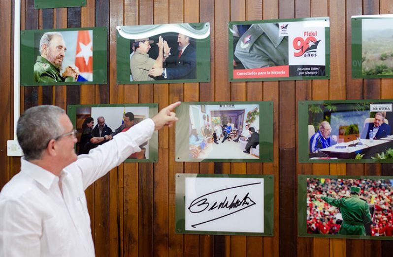 Julio César González Marchante points to pictures of former Cuban leader Fidel Castro on Thursday at the Cuban Embassy on High Street. 
The pictures were mounted as part of an exhibition to mark Cuban Cultural Day, which was observed on Thursday.