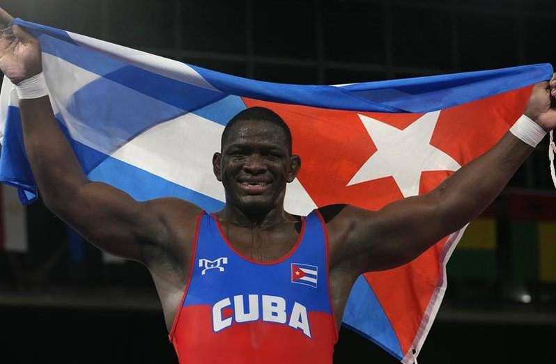 Cuba's Mijain Lopez Nunez celebrates winning his fourth Olympic wrestling gold medal.