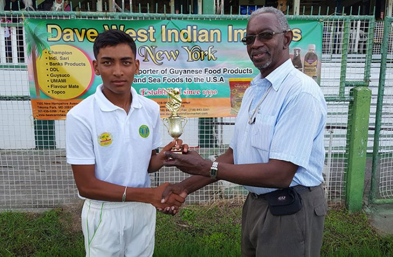 Marvan Prashad accepts his man-of-the-match prize from match referee Grantley Culbard.