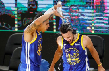Stephen Curry was soaked by fellow Warriors player Juan Toscano-Anderson after the win.