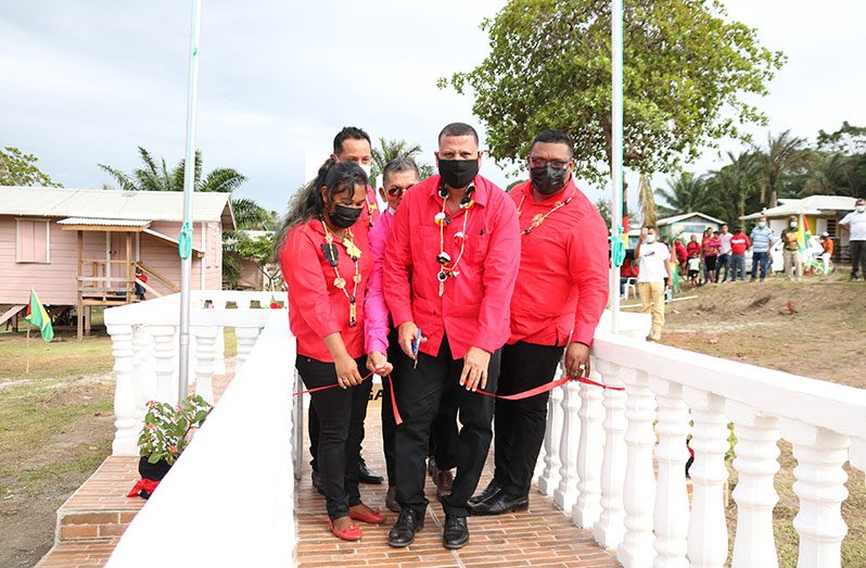 Minister of Housing and Water, Collin Croal, in his capacity as Parliamentary representative for Region One, cuts the ceremonial ribbon to declare the monument open. The minister is flanked by Regional Chairman, Brentnol Ashley and Regional Vice-chairman, Annansha Peters, and other officials of the region