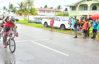 Flashback! Junior Niles raises his hand in triumph as he crosses the finish line to win the GCF’s veterans’ Under-45, 50-mile national cycle road race last year. (Photo by Samuel Maughn)