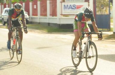 Kravitz Jeffrey (right) leads Alonzo Ambrose and Akeem Arthur (hidden in picture) during their time trial event yesterday in Suriname (Rawle Toney photo)