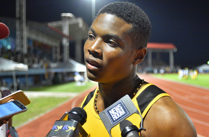 Daniel Williams speaking to reporters after his record-breaking run in the Boys U-18 100M finals (Samuel Maughn photo)
