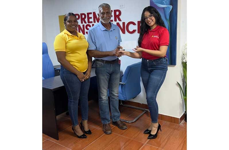 DCB Secretary Davteerth Anandjit (centre) receives the sponsorship from Ariadna Fonseca in the presence of Aleyah Peterkin