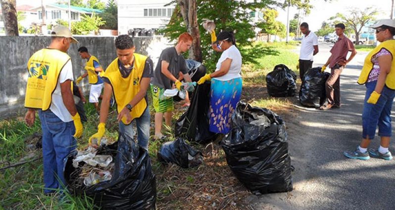 Members of the Demerara Branch cleaning the area around the Demerara Cricket Club ground