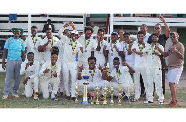 An elated DCC team celebrate with their spoils.