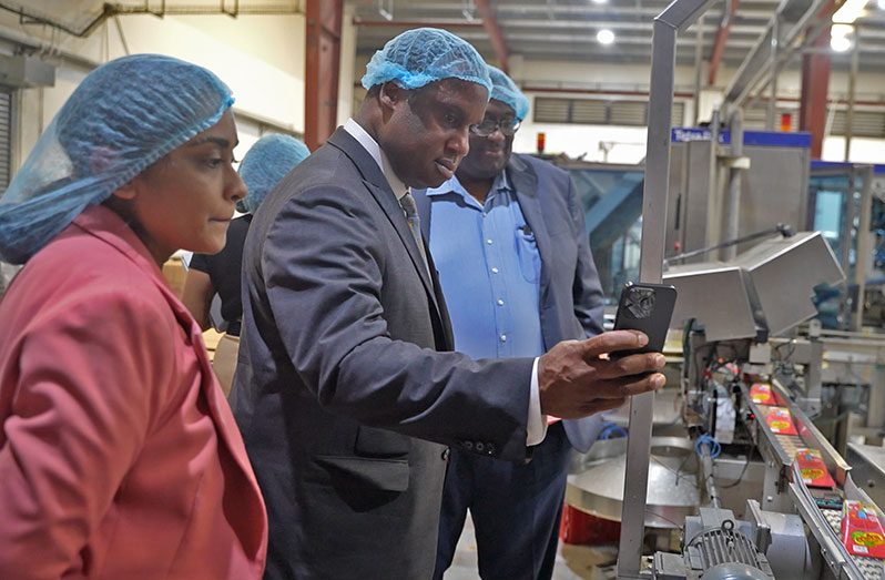 TOPCO Plant Manager Rebecca Rampher-Adams, Congressman Jonathan L. Jackson, and Master Distiller Lennox Shaun Caleb