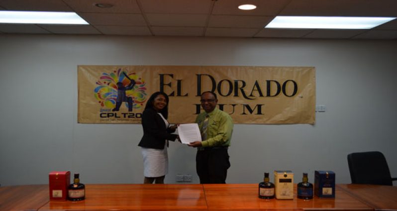 DDL Marketing Director Sharda Veeren-Chand (left) displays the contracts with CPL OPCO Team Operations Manager, Omar Khan.