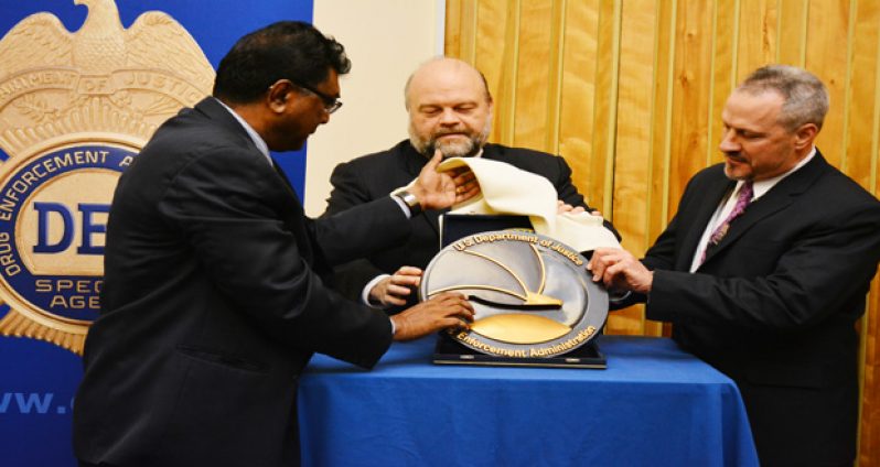 DEA Regional Director, Matthew Donahue; Public Security Minister, Khemraj Ramjattan; and U.S. Ambassador Perry Holloway unveil the DEA plaque on Wednesday at the U.S. Embassy in Georgetown