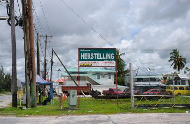 The village name on a signboard on the roadside