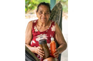 Yvonne Jaggernath displaying her homemade mango achar and bird pepper sauce (Delano Williams photos)