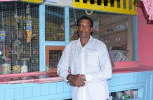 Ramlall Rajmonie poses by his shop (Delano Williams photos)