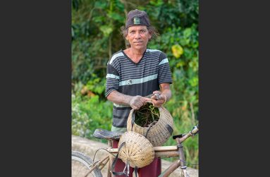 Rajendra Ramnarace lives comfortably as the only resident in a small village in East Canje called Speculation. He is a fisherman and fishing quake maker (a basket-like container used for holding caught fish). In this photo, Rajendra displays his hand-made quake as he returns home from fishing (Delano Williams photo)