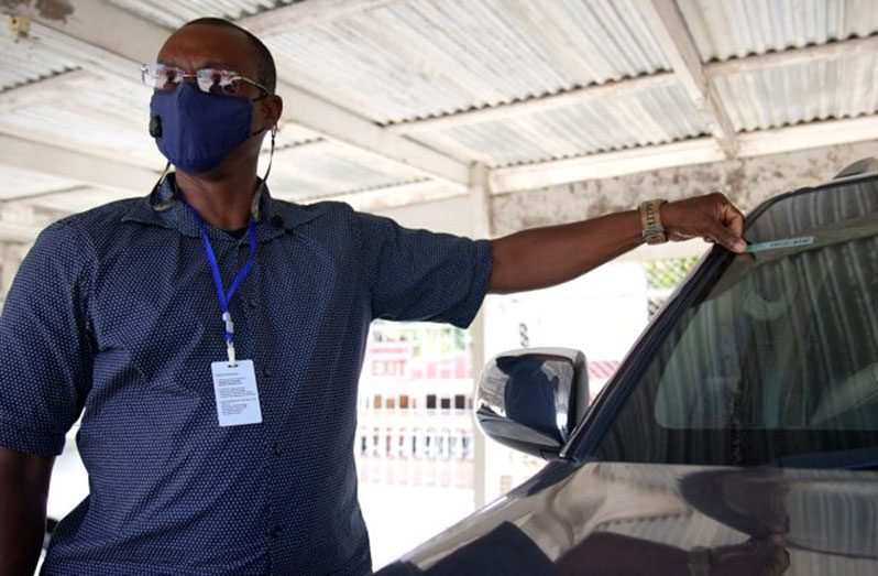 DHBC General Manager Wayne Watson points out the RFID tag on his vehicle (Photo courtesy of News Room)