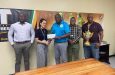 Banks DIH Triskits Pinechill Brand Manager, Shenisa Frdericks, hands over the sponsorship cheque to GSCL President, Ian John. Others in picture, from left, are Brand Manager Dwaine Bristol, Water Beverage Manager, Colin King and Outdoor Events Manager, Mortimer Stewart