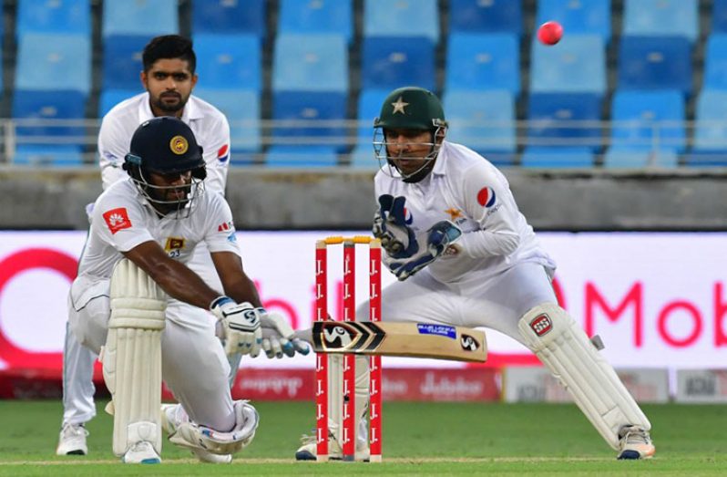 Dimuth Karunaratne lays into a reverse-sweep, Pakistan v Sri Lanka, 2nd Test, Dubai, 1st day yesterday.