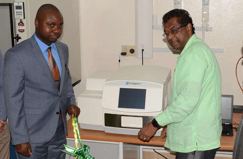 Director of GFSL, Delon France and Minister of Public Security, Khemraj Ramjattan cut the ceremonial ribbon to commission the DNA machine.