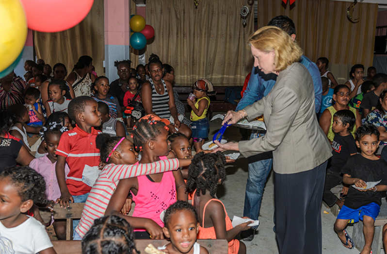 United States Ambassador to Guyana Sarah- Ann Lynch, distributing  snacks  to the children – Delano Williams photo