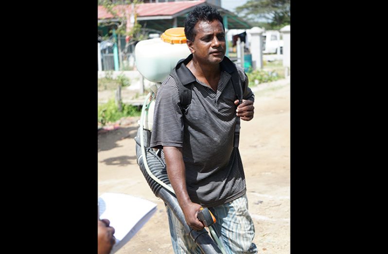 Farmer, Mahadeo Mohabir upon his return home from spraying his farm (Carl Croker photos)